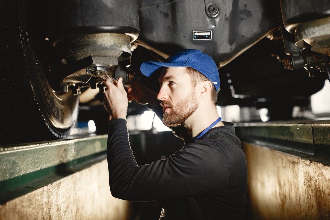 A technician inspecting a commercial vehicle in the workshop